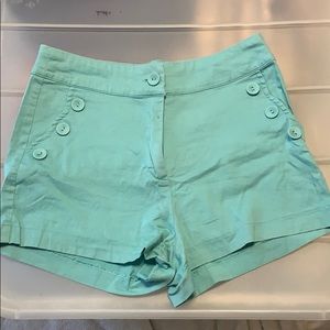 Teal shorts with button pocket detail